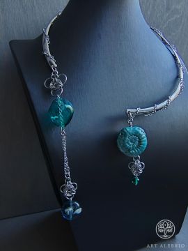 Lagoon. The necklace is made using the technique of chainmail weaving from steel, using ceramics and handmade glass.